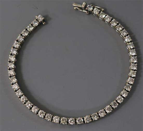 An 18ct white gold and diamond line bracelet, set with forty four round cut stones, with a total diamond weight of approximately